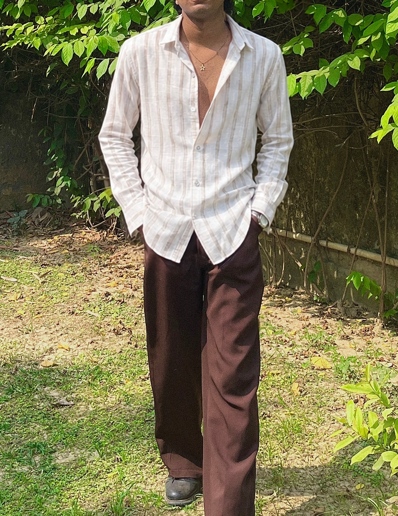 Front view of the Mauji linen shirt, relaxed fit, worn open at the collar with brown trousers