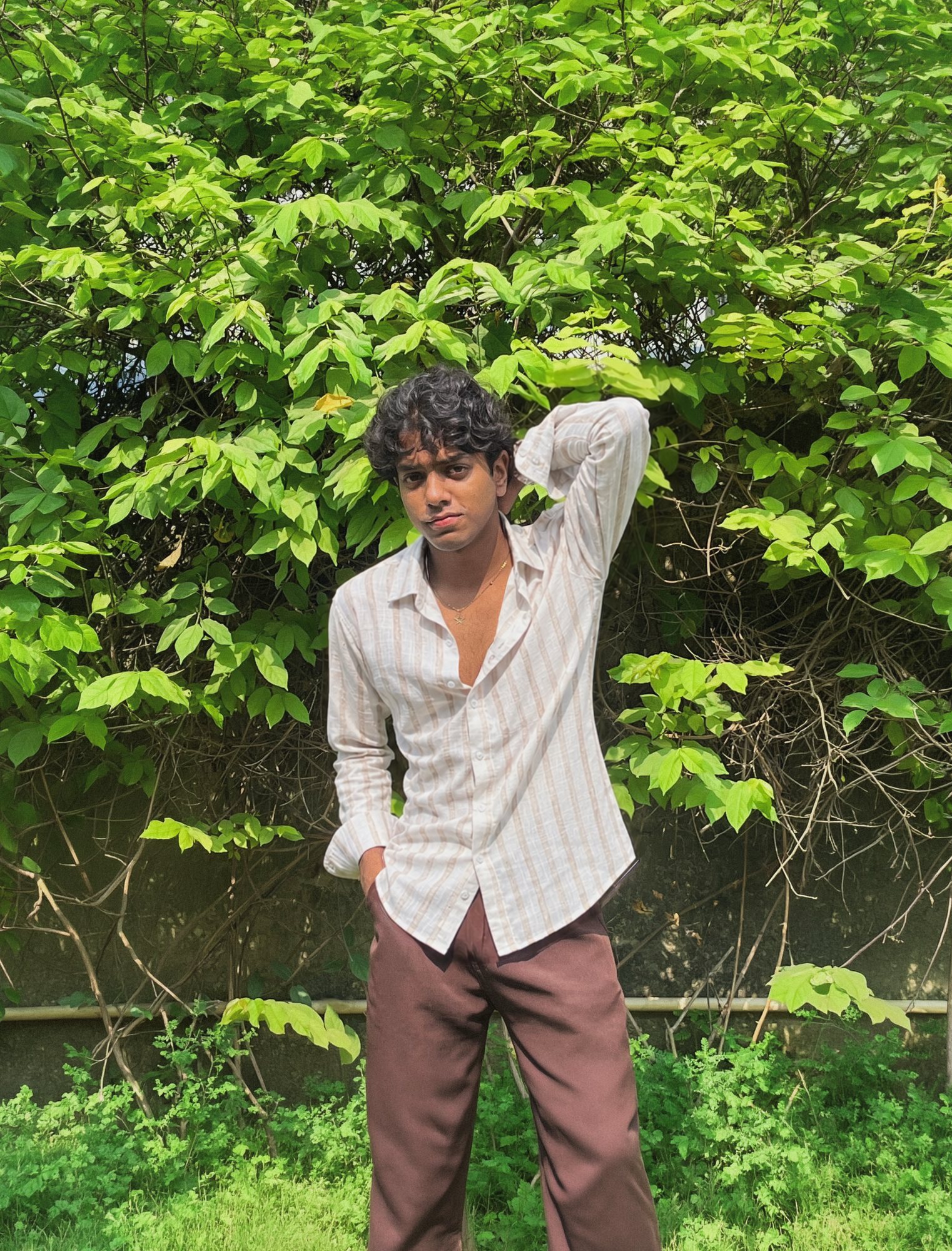 Model in the Mauji ivory and sand striped linen shirt, looking at the camera