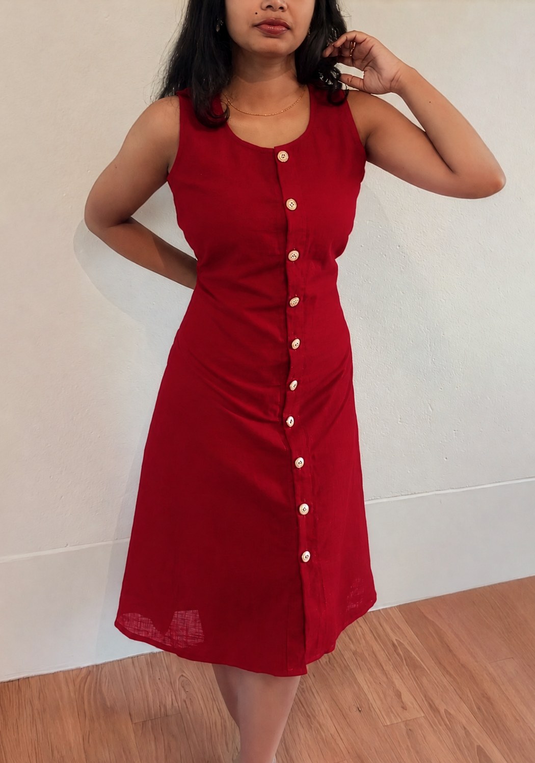 Noor crimson red 100% cotton midi dress, full-length front view with button-front detailing and a fitted waist